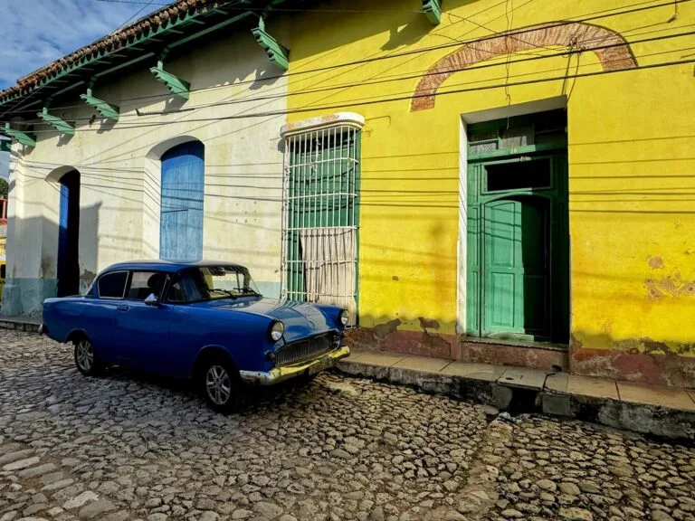 Classic car outside colourful houses, Trinidad, Cuba